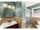 Stylish bathroom featuring a glass-enclosed shower and a decorative vanity mirror at 1421 Downs Sw Dr, Atlanta, GA 30311