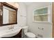 Well-lit bathroom with a modern vanity, updated fixtures, and a window for natural light at 1421 Downs Sw Dr, Atlanta, GA 30311