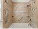 Updated bathroom featuring a soaking tub, tiled walls, and convenient grab bars at 1421 Downs Sw Dr, Atlanta, GA 30311