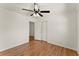 Well-lit bedroom with hardwood floors, ceiling fan, and ample closet space at 1421 Downs Sw Dr, Atlanta, GA 30311