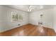 Spacious bedroom featuring hardwood floors, large window, and a connecting bathroom at 1421 Downs Sw Dr, Atlanta, GA 30311