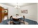Cozy dining room featuring a round table, elegant chandelier, and stylish decor at 1421 Downs Sw Dr, Atlanta, GA 30311