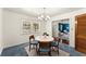 Bright dining area with natural light and a view, complemented by a modern light fixture at 1421 Downs Sw Dr, Atlanta, GA 30311