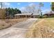 Charming brick home featuring a long driveway and landscaped front yard at 1421 Downs Sw Dr, Atlanta, GA 30311