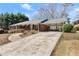 Charming brick home featuring a long driveway and covered carport at 1421 Downs Sw Dr, Atlanta, GA 30311