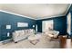 Bright living room with blue walls, large windows, and comfortable furniture at 1421 Downs Sw Dr, Atlanta, GA 30311