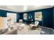 Bright living room with blue walls, large windows, and modern decor at 1421 Downs Sw Dr, Atlanta, GA 30311
