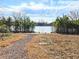 Lakeside common area with gravel path leading to the pond and abundant surrounding vegetation at 2724 Mourning Dove Drive Lot 32, Grayson, GA 30017