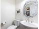 Elegant powder room with pedestal sink, decorative mirror, and neutral decor at 4541 Wieuca Ne Rd, Atlanta, GA 30342