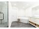 Luxurious bathroom featuring a soaking tub, glass shower, marble countertops, and hardwood-style tile flooring at 4541 Wieuca Ne Rd, Atlanta, GA 30342