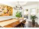 Elegant dining room with a dark wood table, an artistic painting, and a backyard view at 4541 Wieuca Ne Rd, Atlanta, GA 30342