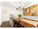 Chic dining room with dark wood table, modern art, and view into the kitchen at 4541 Wieuca Ne Rd, Atlanta, GA 30342