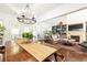 Open-concept dining room adjacent to living room, featuring ample natural light and modern decor at 4541 Wieuca Ne Rd, Atlanta, GA 30342
