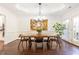 Elegant dining room with modern chandelier, decorative painting, and doors to backyard at 4541 Wieuca Ne Rd, Atlanta, GA 30342