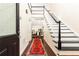 Grand foyer with dark hardwood floors, staircase with black accents, and beautiful runner at 4541 Wieuca Ne Rd, Atlanta, GA 30342