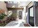 Inviting front entrance with a courtyard, stylish black door, and beautiful plants in pots at 4541 Wieuca Ne Rd, Atlanta, GA 30342