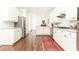 Bright, spacious kitchen features white cabinetry, stainless steel appliances, and an eye-catching red rug at 4541 Wieuca Ne Rd, Atlanta, GA 30342