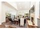 Bright living room with fireplace, TV, vaulted ceiling, and seamless flow to dining area at 4541 Wieuca Ne Rd, Atlanta, GA 30342