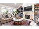 Inviting living room featuring a fireplace, built-in shelving, and views of the backyard at 4541 Wieuca Ne Rd, Atlanta, GA 30342