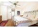 Comfortable main bedroom with hardwood floors, a tray ceiling, a ceiling fan, and ample natural light at 4541 Wieuca Ne Rd, Atlanta, GA 30342