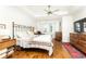 Comfortable main bedroom with hardwood floors, a tray ceiling, a ceiling fan, and ample natural light at 4541 Wieuca Ne Rd, Atlanta, GA 30342