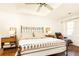 Comfortable main bedroom with hardwood floors, a tray ceiling, a ceiling fan, and ample natural light at 4541 Wieuca Ne Rd, Atlanta, GA 30342