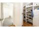 Spacious walk-in closet with custom shelving, hardwood floors, and ample storage for clothing and accessories at 4541 Wieuca Ne Rd, Atlanta, GA 30342
