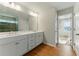 Bathroom featuring a double sink vanity, modern lighting and wood-look floors at 20 Running Nw Ter, Cartersville, GA 30121