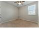 Simple bedroom with a ceiling fan, window letting in natural light, and neutral carpet at 20 Running Nw Ter, Cartersville, GA 30121