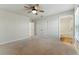 Spacious bedroom with a ceiling fan and neutral carpet, connecting to an adjacent bathroom at 20 Running Nw Ter, Cartersville, GA 30121