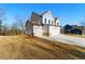 Side view of home highlighting manicured lawn, attached two-car garage, and classic architectural design at 20 Running Nw Ter, Cartersville, GA 30121