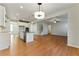 Bright, open-concept kitchen with white cabinets, stainless steel appliances, and wood floors at 20 Running Nw Ter, Cartersville, GA 30121