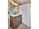 Bathroom with single sink vanity with marble countertop, dark wood cabinets, and decorative light fixture at 2360 Leisure Lake Dr, Atlanta, GA 30338