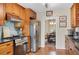 Well-lit kitchen featuring stainless steel appliances, wooden cabinets, and tile backsplash at 2360 Leisure Lake Dr, Atlanta, GA 30338