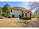 Back exterior showing sunroom and backyard with trees behind the home at 305 Collegiate Dr, Powder Springs, GA 30127