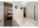 Bright bathroom with a white vanity and a view into the carpeted bedroom with a bed at 305 Collegiate Dr, Powder Springs, GA 30127