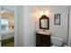 Bathroom vanity with mirror, towels, and adjacent bedroom at 305 Collegiate Dr, Powder Springs, GA 30127