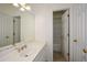 Bright bathroom featuring double closets, a sink and a shower with white tile at 305 Collegiate Dr, Powder Springs, GA 30127