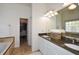 Main bathroom with double sink vanity and view of closet at 305 Collegiate Dr, Powder Springs, GA 30127