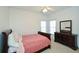 Bedroom with a single bed, dark wood furnishings, and dresser beneath two windows at 305 Collegiate Dr, Powder Springs, GA 30127