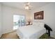 Bright bedroom with a neutral color palette, large window and fan at 305 Collegiate Dr, Powder Springs, GA 30127