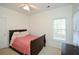 Bedroom featuring a single bed and dresser beneath a window, with a closet nearby at 305 Collegiate Dr, Powder Springs, GA 30127
