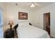 Well-lit bedroom with a ceiling fan and picture hanging on wall at 305 Collegiate Dr, Powder Springs, GA 30127