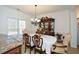 Elegant dining room featuring a chandelier, china cabinet, and neutral color palette at 305 Collegiate Dr, Powder Springs, GA 30127