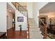 Elegant two-story foyer with hardwood floors, a staircase with wrought iron railings, and neutral paint at 305 Collegiate Dr, Powder Springs, GA 30127