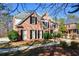 Lovely brick home with classic shutters, complemented by neatly trimmed bushes at 305 Collegiate Dr, Powder Springs, GA 30127