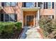 Inviting entryway with a double wooden door, sidelights, and manicured bushes along the walkway at 305 Collegiate Dr, Powder Springs, GA 30127
