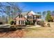 Charming two-story brick home with well-manicured landscaping and classic black shutters at 305 Collegiate Dr, Powder Springs, GA 30127