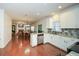 Bright kitchen with granite countertops, tile backsplash, white cabinetry and stainless steel appliances at 305 Collegiate Dr, Powder Springs, GA 30127