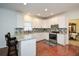 Bright kitchen with granite countertops, tile backsplash, white cabinetry and stainless steel appliances at 305 Collegiate Dr, Powder Springs, GA 30127